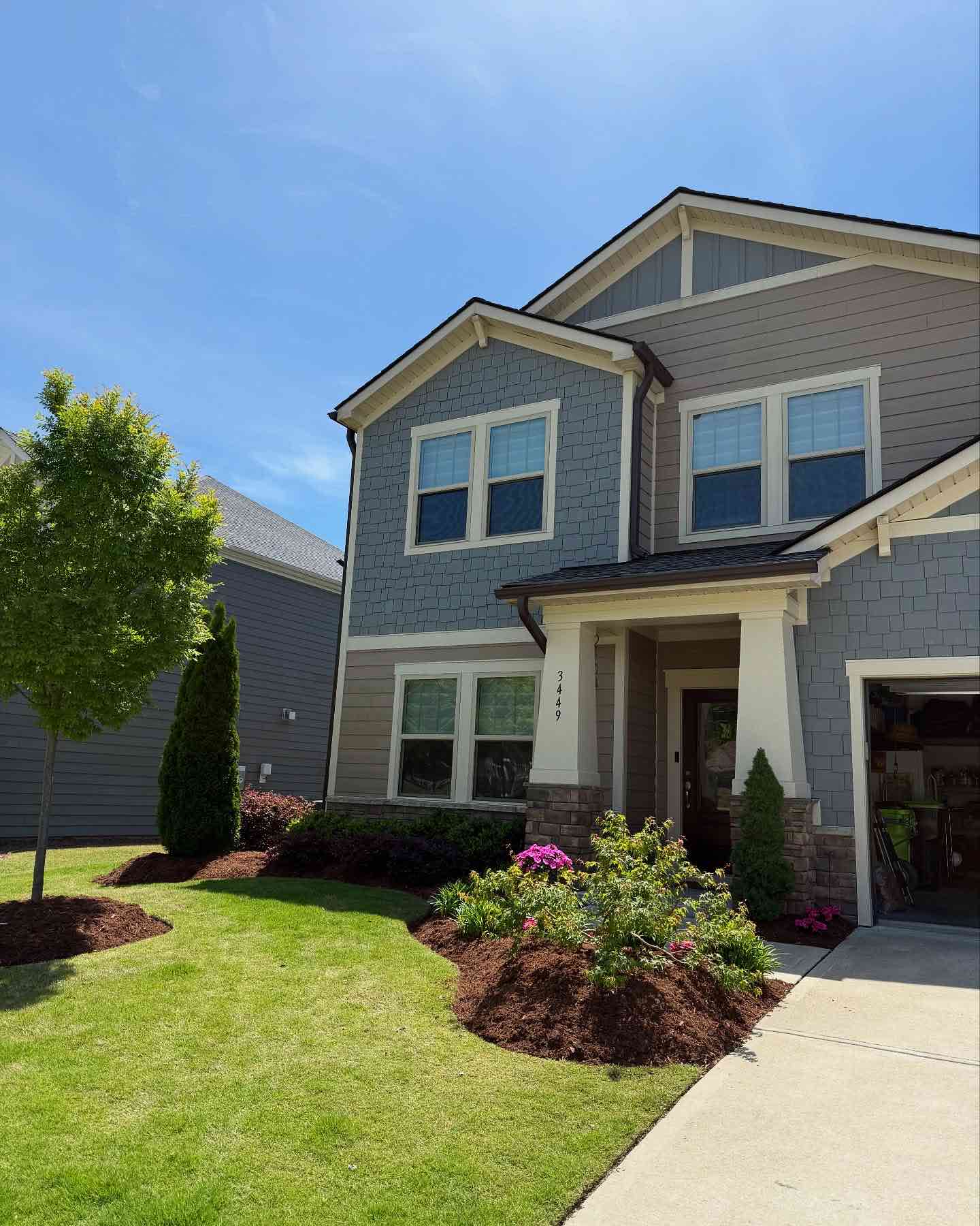 Apex, NC front yard landscaping with freshly edged mulch beds and new mulch around foundation plants by MC Landscaping.