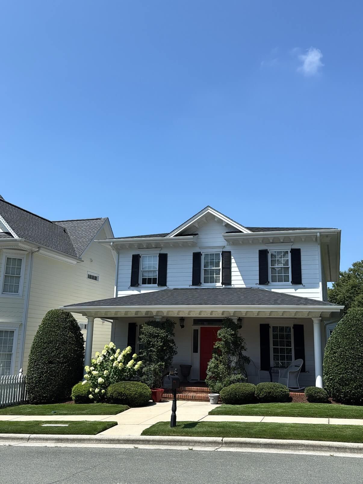 Front yard landscape design in Apex NC with foundation planting, trimmed shrubs, structured bed layout, and clean curb appeal landscaping
