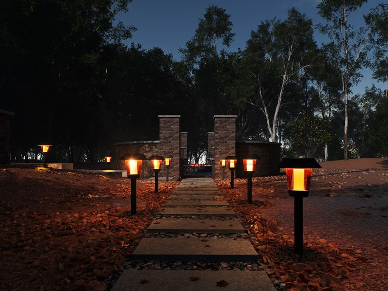 Path lighting along walkway leading to fire pit at night in Raleigh NC by MC Landscaping