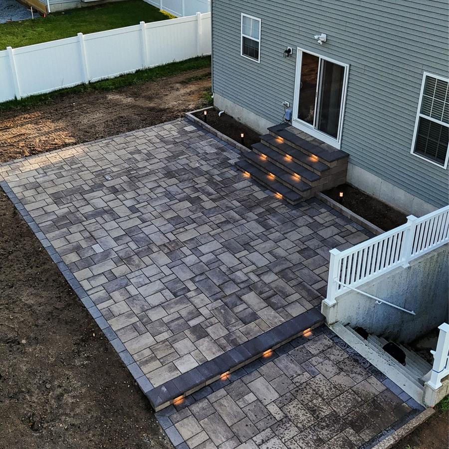 paver patio with stone border by MC Landscaping in Raleigh, NC