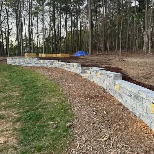 retaining wall installation with mulch and grading in Raleigh Durham NC