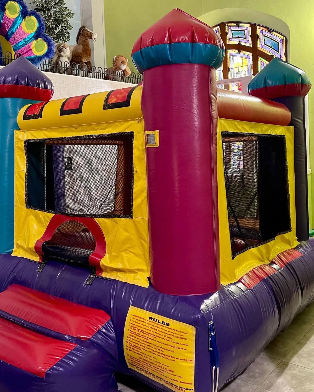 Child climbing the safe indoor rock wall