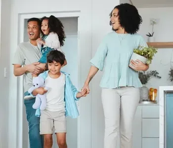 Happy family walking into a bright new home together, symbolizing confident home buying and trusted buyer representation in Fremont, CA.