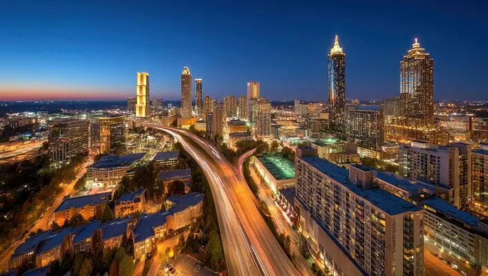 Atlanta cityscape at dusk showing high-rise towers and glowing streets