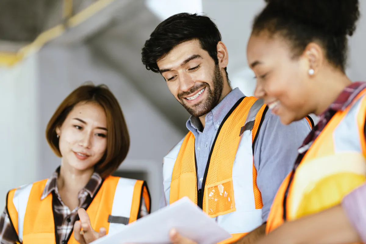 Team of man and two women construction workers