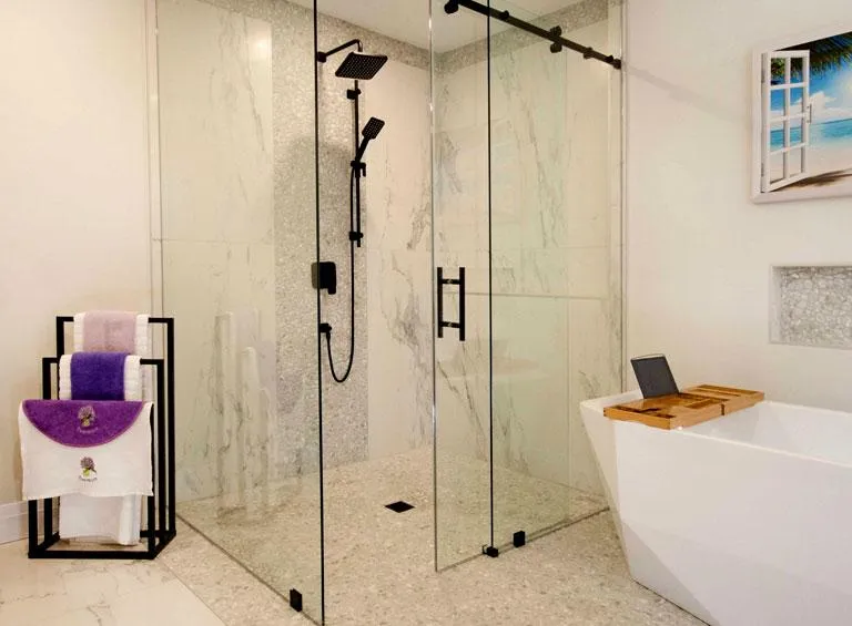 Luxury glass-enclosed steam shower with bench seating in modern Durham Region bathroom