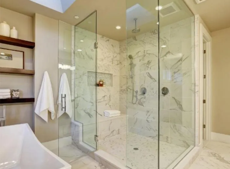 Luxury glass-enclosed steam shower with bench seating in modern Durham Region bathroom