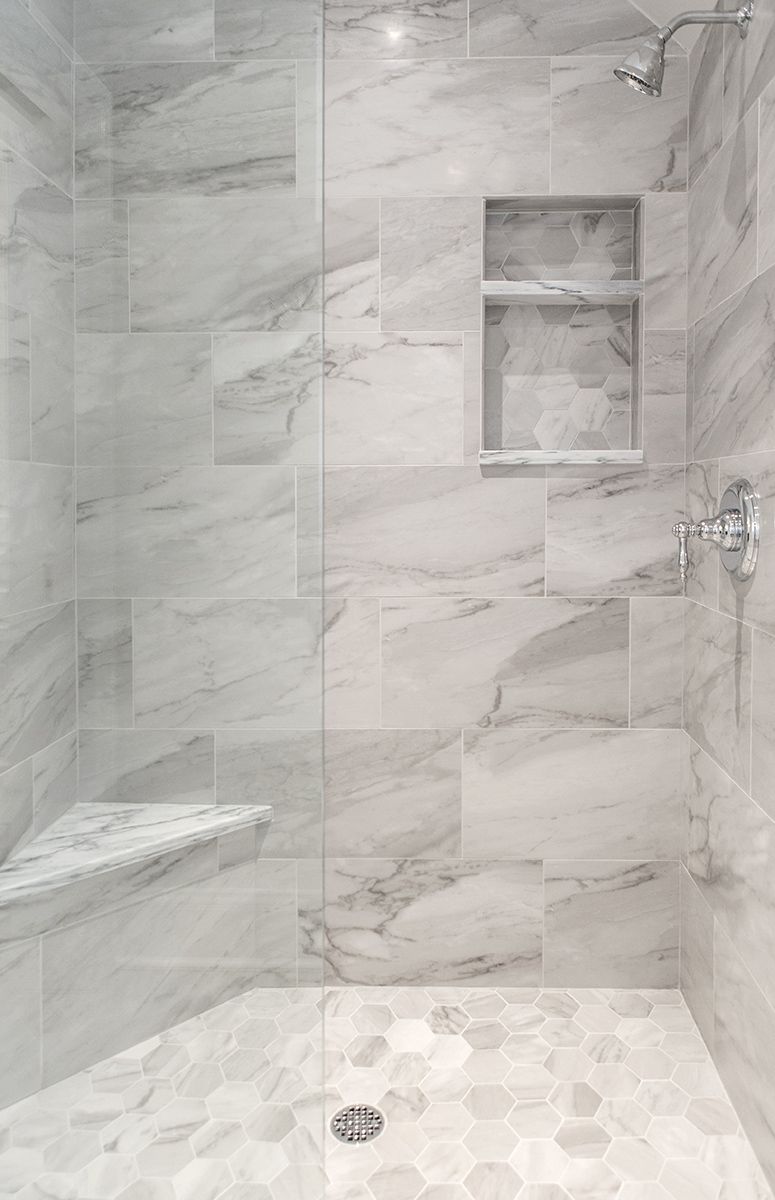 Custom built-in corner bench in modern Durham Region bathroom showing tile integration