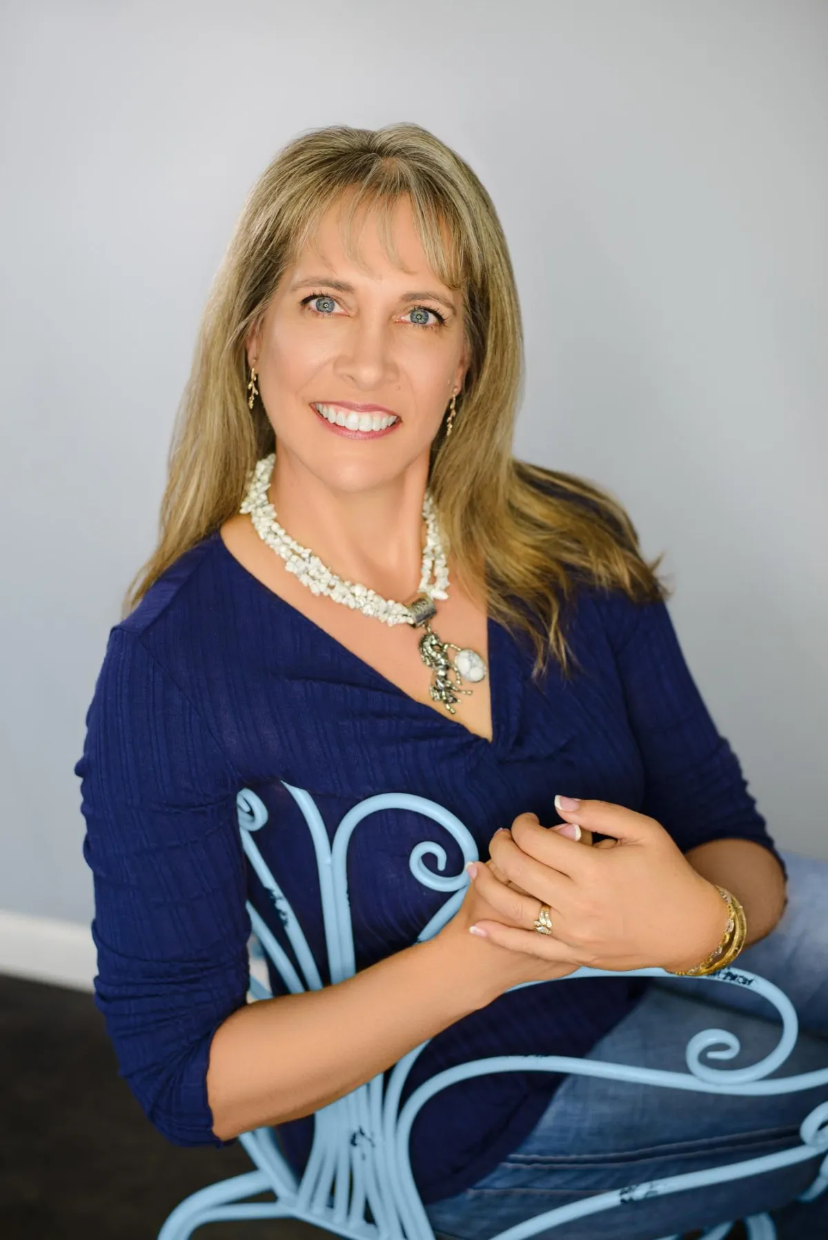 Rebecca on a blue chair