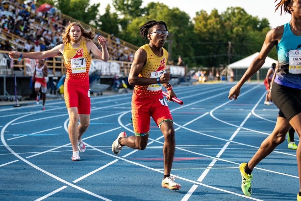 Relay team passing baton