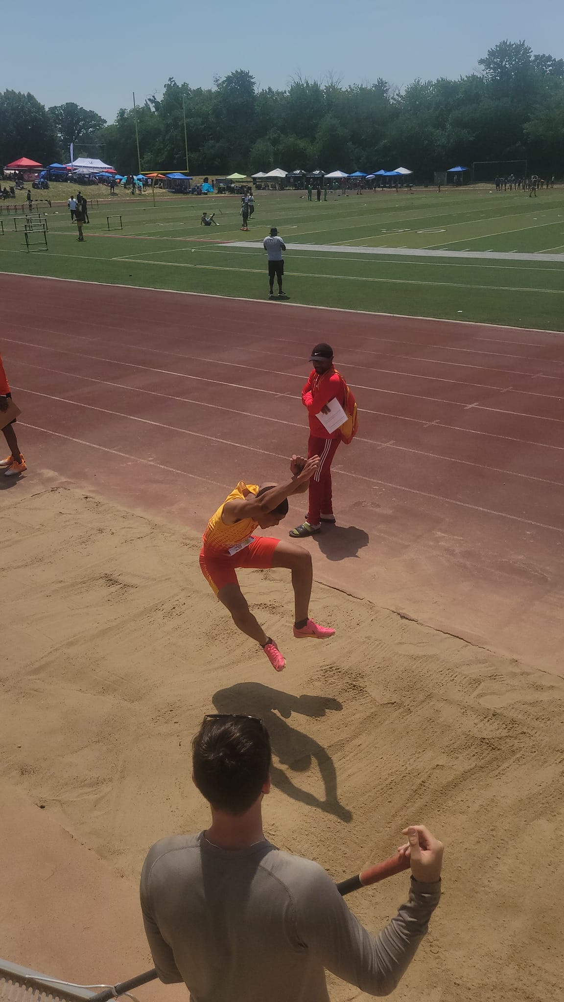 Field athlete mid-jump