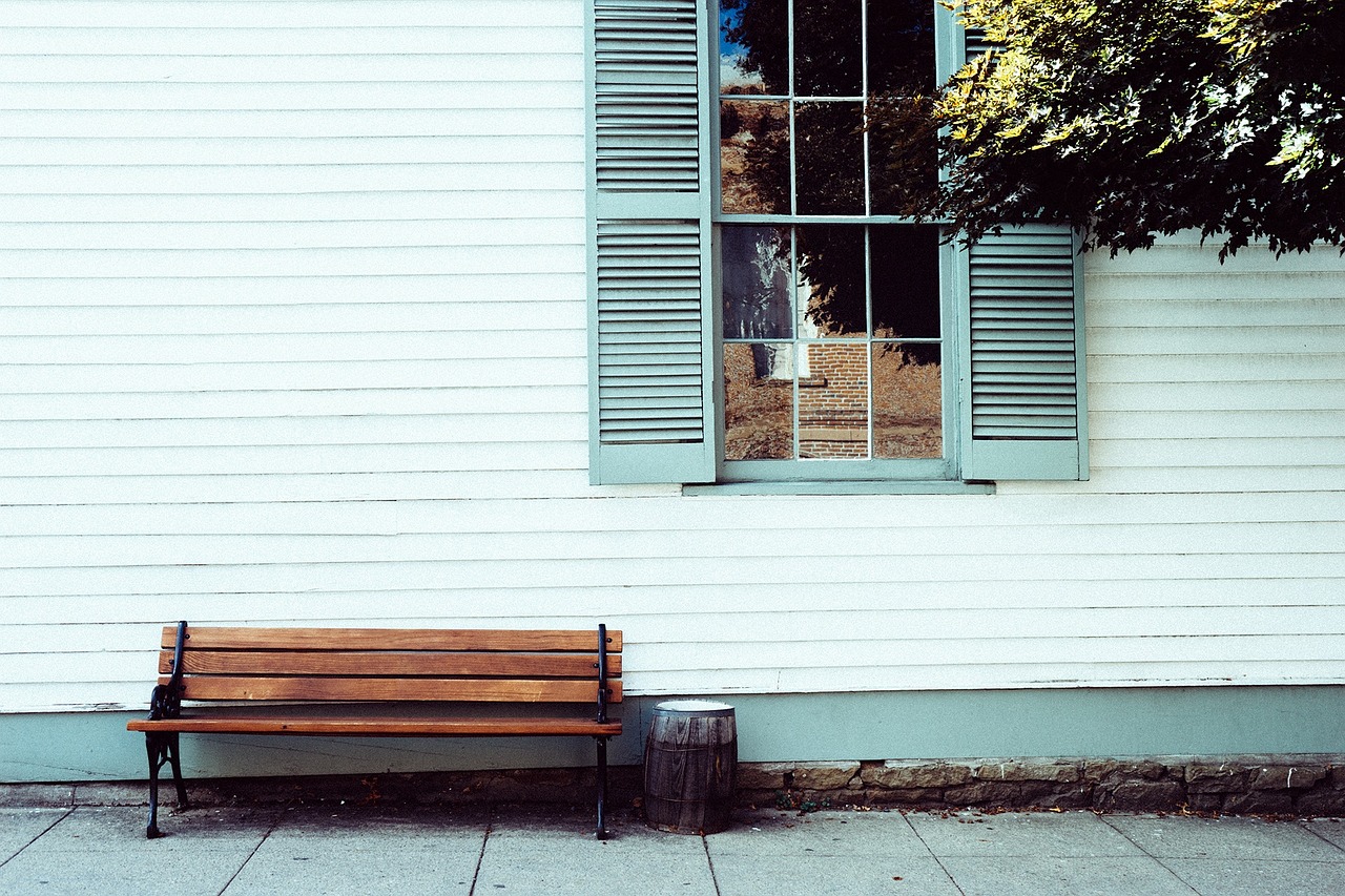 A before-and-after view of a home’s siding replacement, showcasing the transformation from old, worn-out siding to fresh, modern siding that enhances curb appeal and protection.