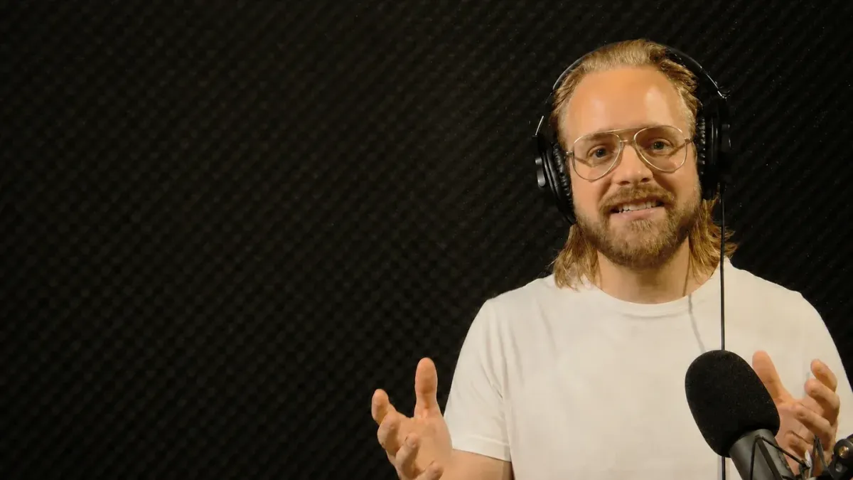 Rasmus MP in a podcast studio with microphone and headphones