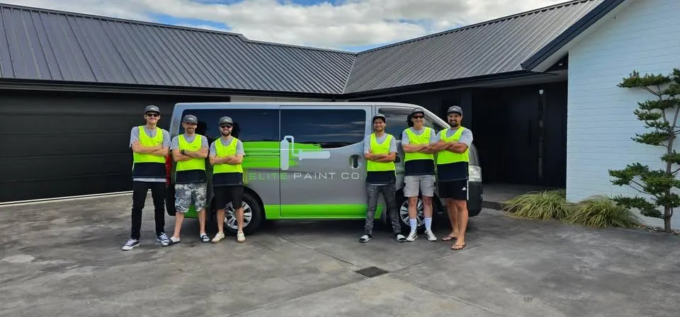 Elite Paint Co. painting team standing in front of branded van outside residential home in Hamilton