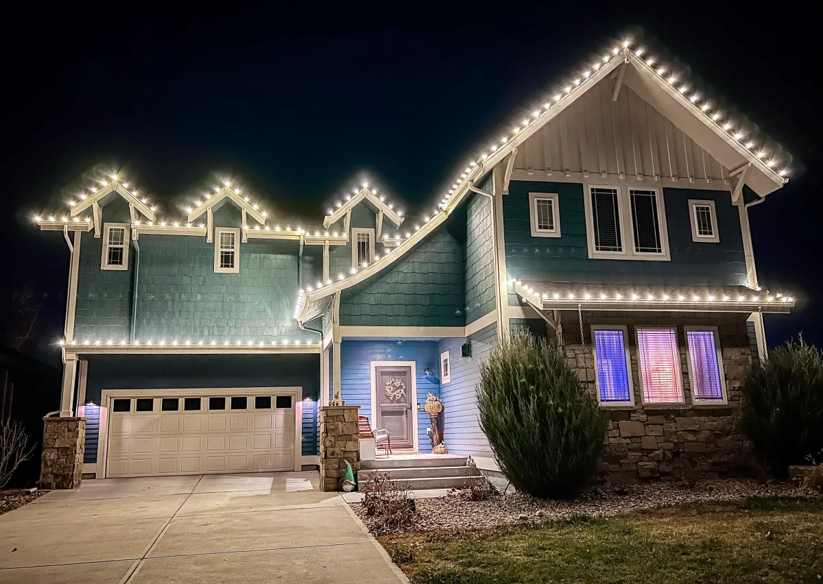 Loveland home with warm white C9 LED roofline Christmas lights professionally installed.