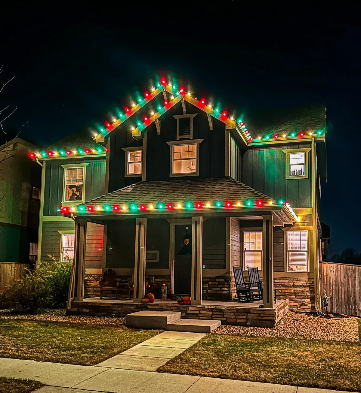 Timnath home with multi-colored C9 LED roofline Christmas lights professionally installed