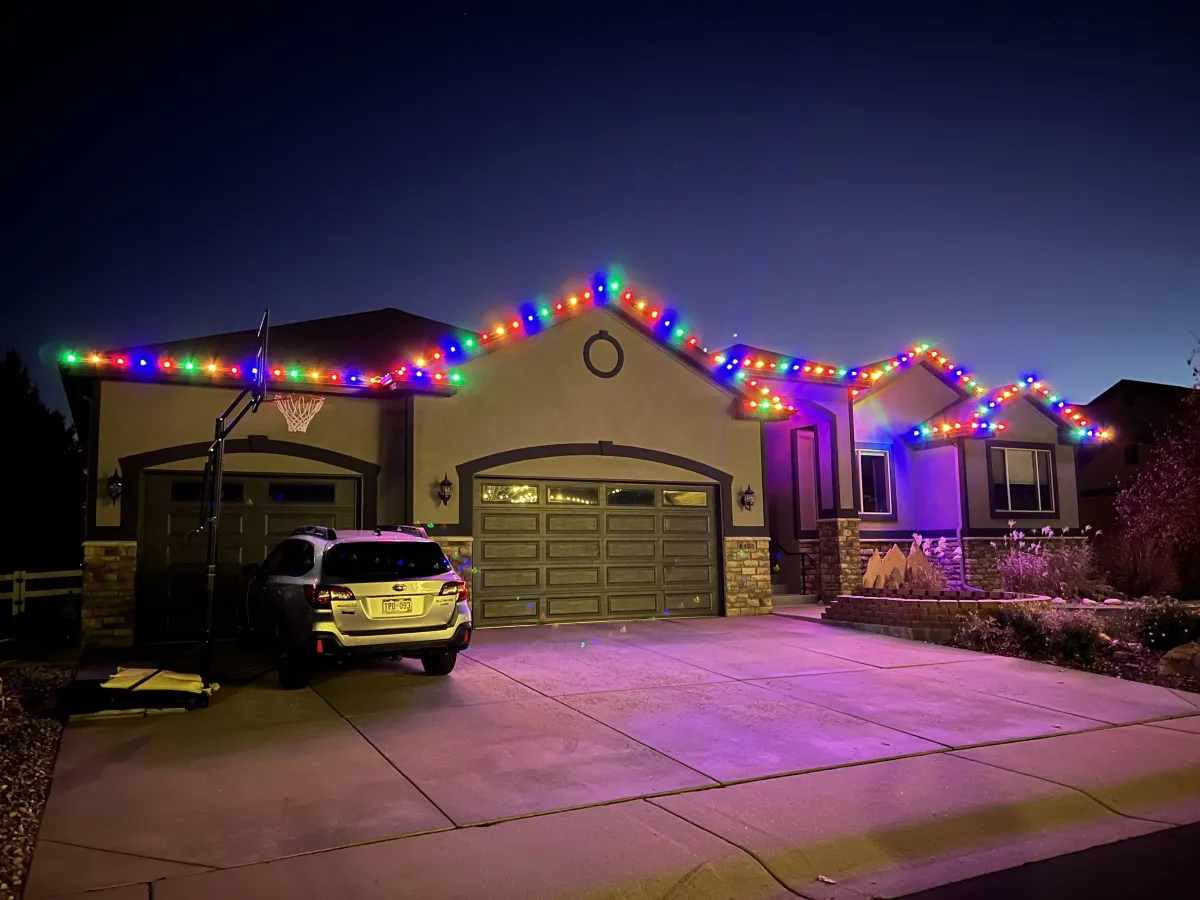Windsor home outlined with multi-colored C9 LED roofline Christmas lights