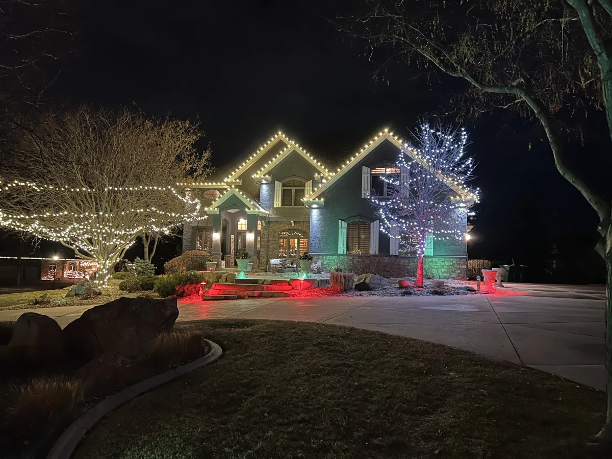 Greeley home with professional C9 LED roofline Christmas lights warm white