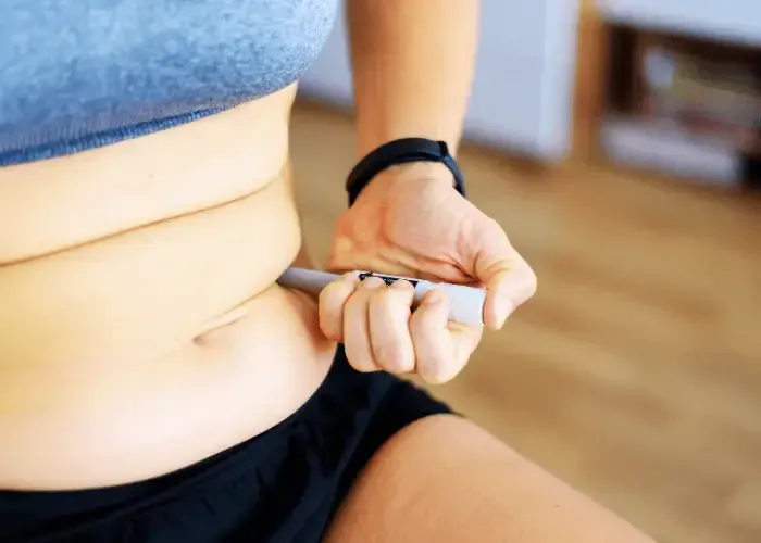 Close up photo of abdomen with fat while injecting GLP-1 in Gainesville GA.