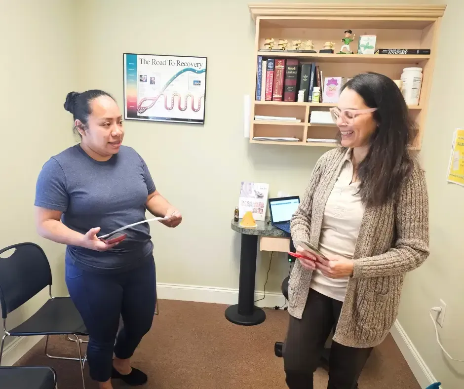 Dr. Patricia Peña consulting with a happy patient