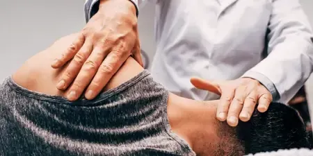 Therapist applying targeted massage therapy in Lawrenceville GA to relieve muscle tension and support spinal adjustments.