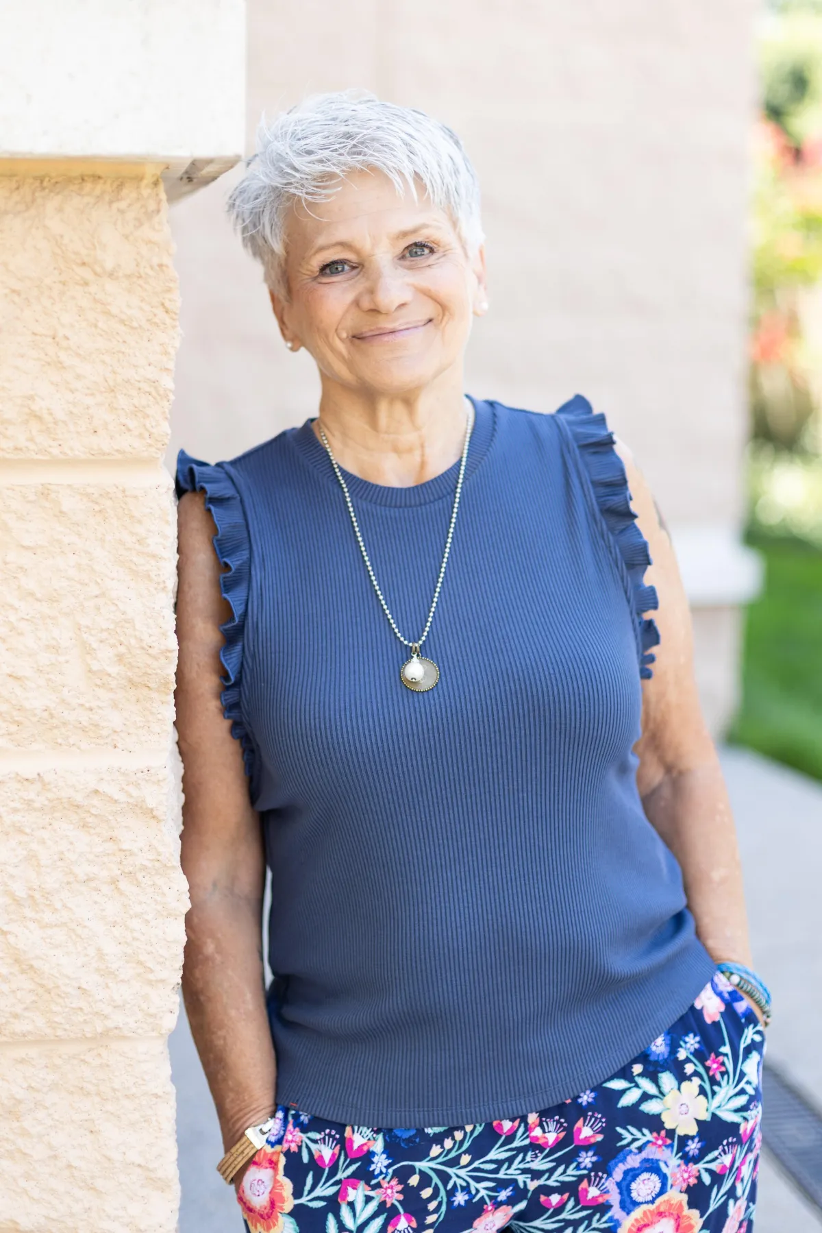 Vickie Turley leaning against stone wall