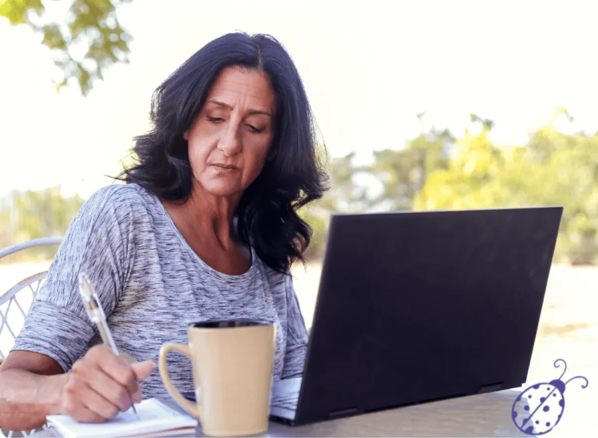 Lonely woman trying to write book with lady bug
