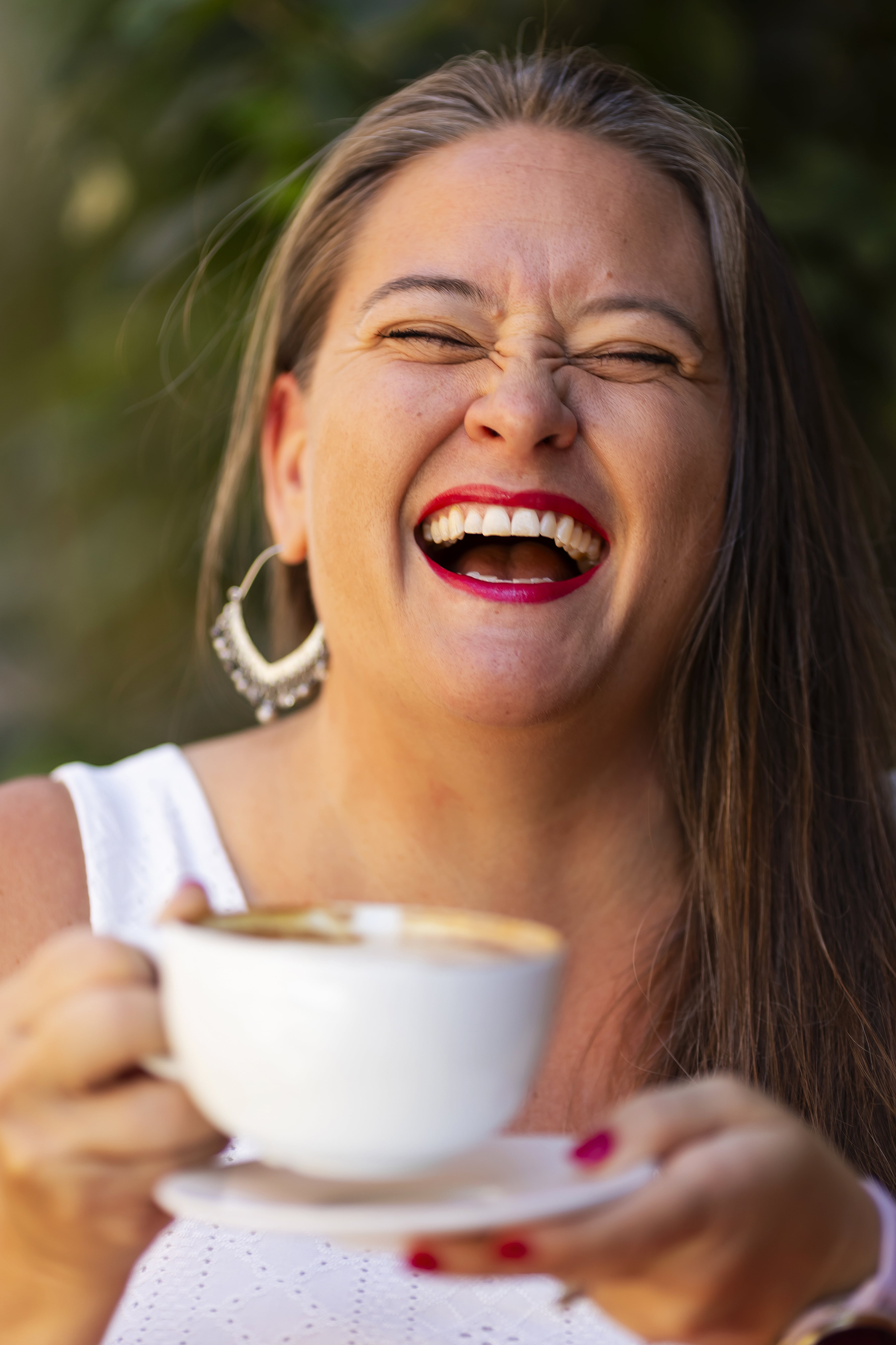 Melanie Colón smiling holding cup