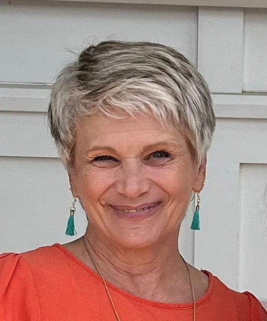 Vickie Turley smiling in orange top