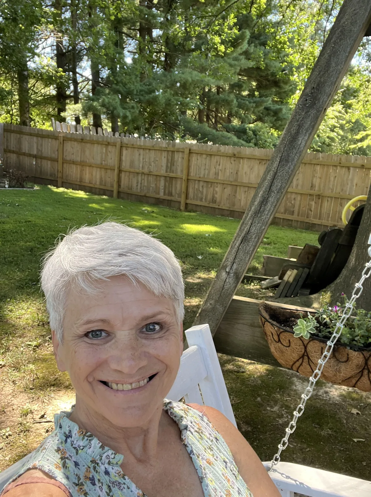 Vickie Turley sitting in swing outside