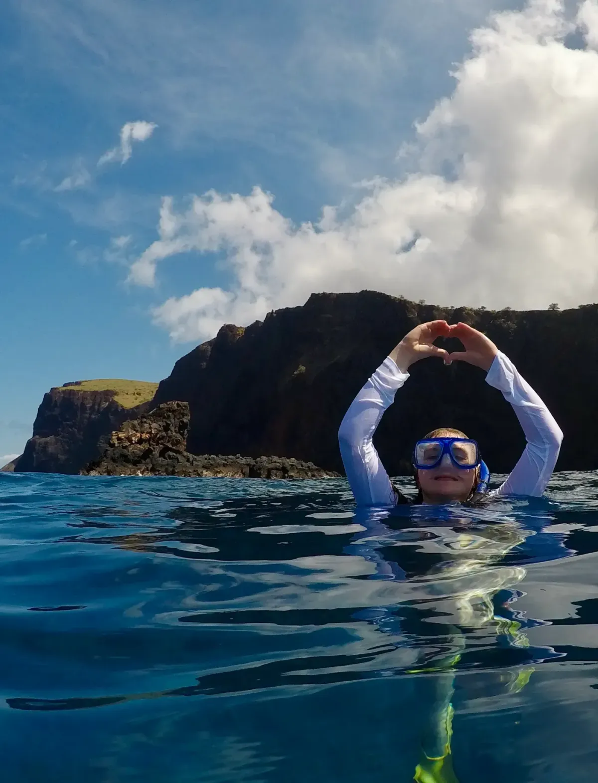 man in blue swimming goggles in blue water during daytime