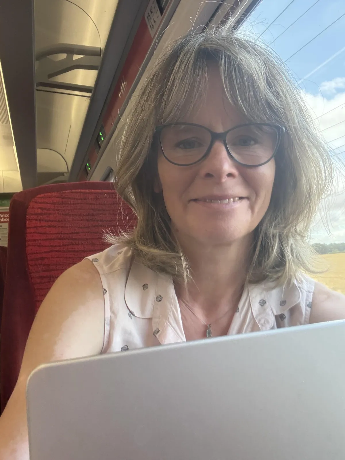 Photo showing Hilary Dancing olisitci Therapist and Coach working on the train