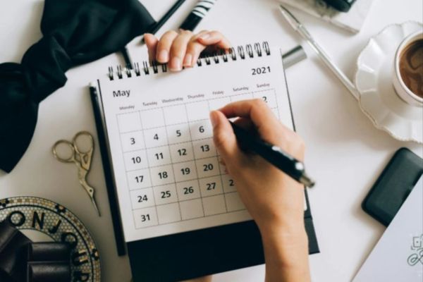 an individual taking note of her mobile or remote online notary appointment