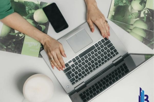 Person using online estate planning platform on laptop to prepare wills and trust documents