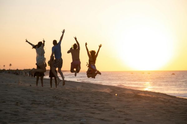Family enjoying spring break beach vacation representing travel preparation and notarized travel consent forms for minors