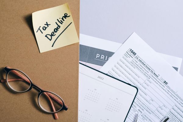 Tax season documents, IRS 1040 form, calendar, and financial paperwork prepared for notarization and filing assistance in Miami