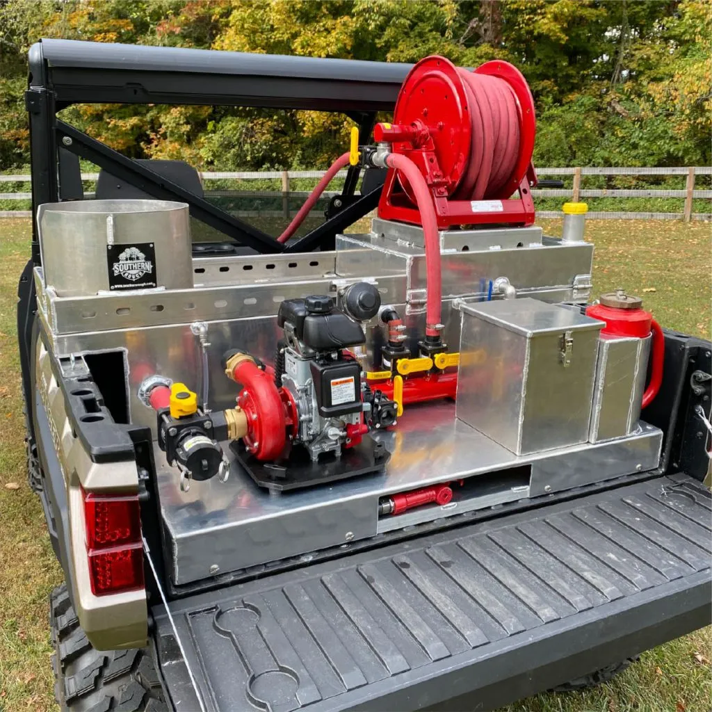 UTV Fire Unit close-up showing pump and tank detail in golden-hour light.