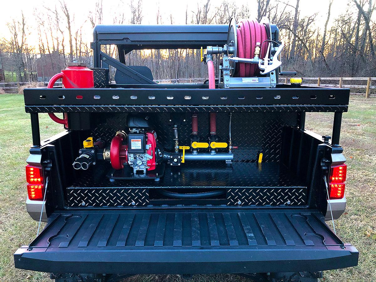 Southern Rough UTV fire unit with custom rack system maximizing storage for forestry hose reel, fire pump, and powder-coated manifold with yellow valves