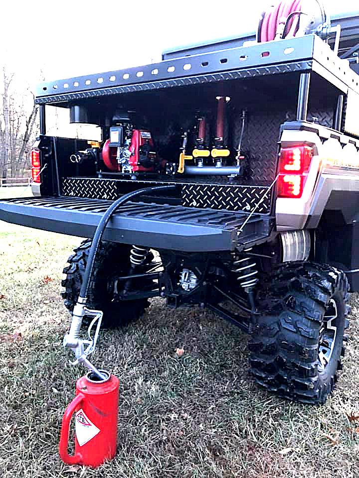 Southern Rough custom UTV fire skid torch fill feature showing three-quarter inch gravity feed hose neatly stored under false floor filling drip torch