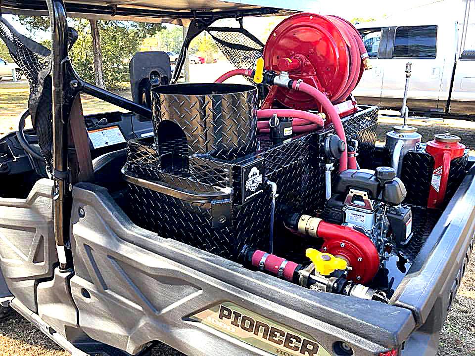 Honda Pioneer UTV equipped with Southern Rough wildland fire skid featuring diamond plate 5-gallon water cooler mount, forestry hose reel, and fire pump