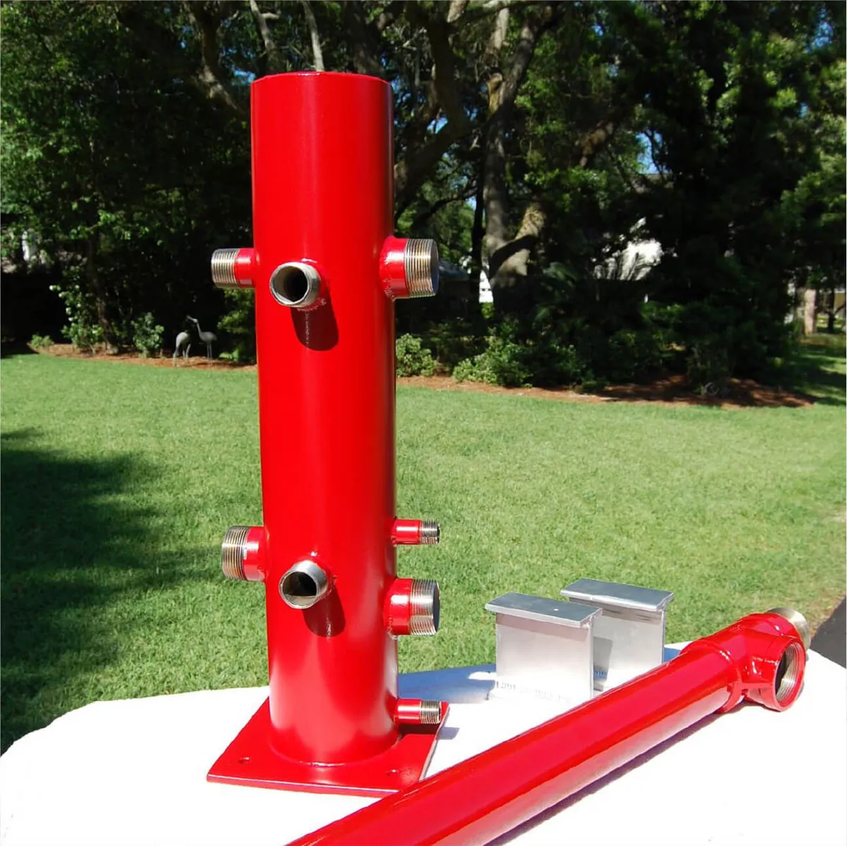 Southern Rough custom-fabricated wildland fire manifold with red powder coat finish, multiple outlet ports, and aluminum mounting hardware