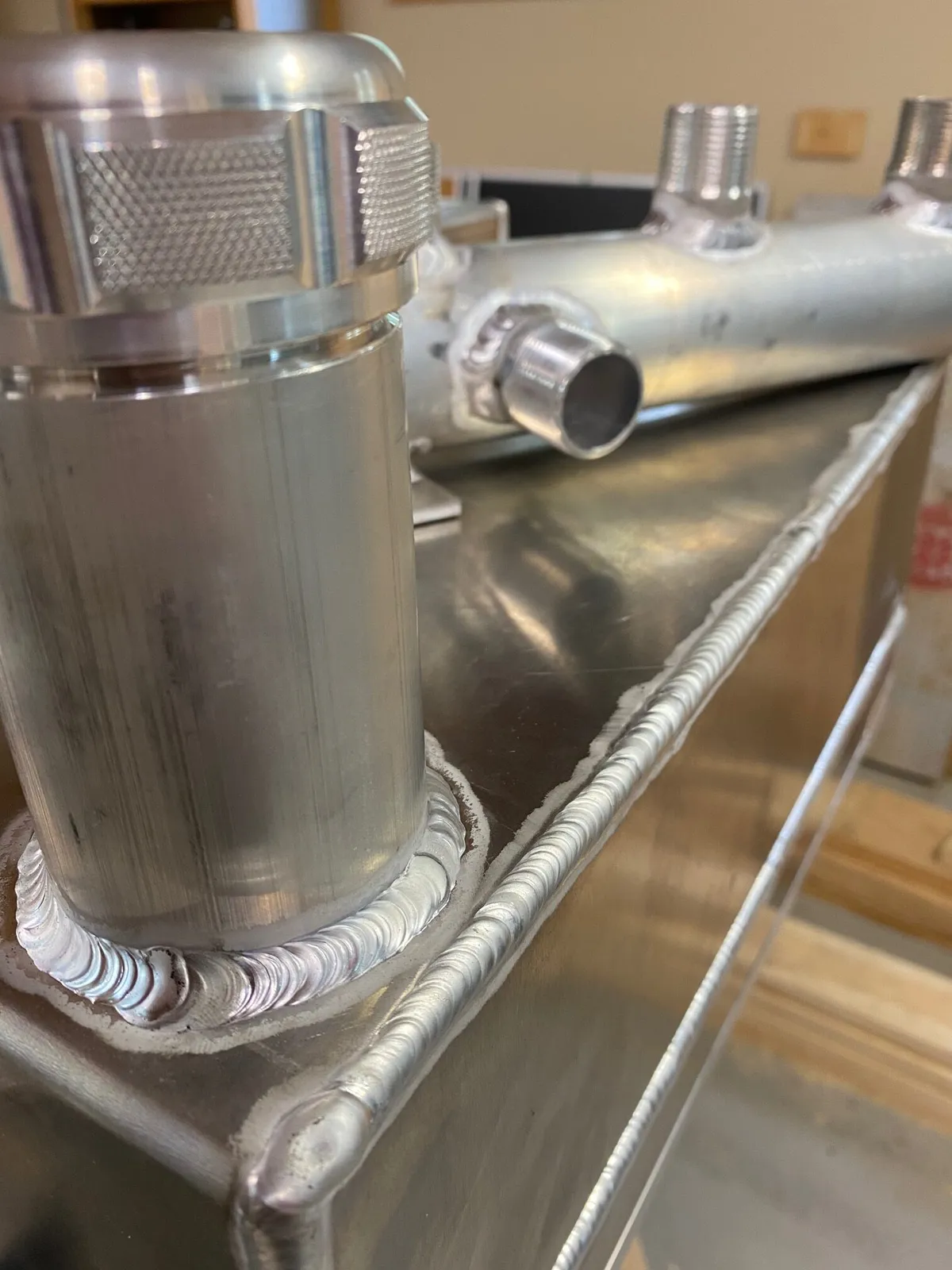 Southern Rough fabricated aluminum fuel cell close-up showing vented billet cap with knurled grip and clean TIG weld seams for wildland fire equipment