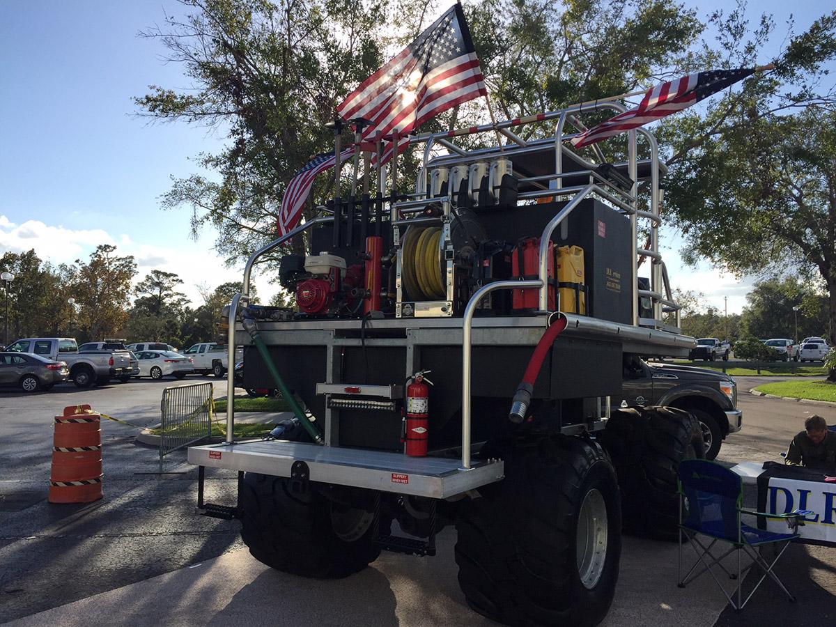 Southern Rough custom swamp buggy wildland fire unit featuring 500-gallon tank, hose reels, fire pump, tool racks, and oversized tires for wetland operations