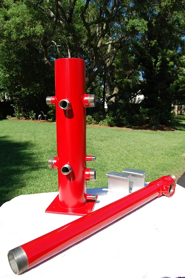 Southern Rough stainless steel wildland fire manifold with red powder coat finish, threaded pipe connections, and aluminum mounting brackets built to order