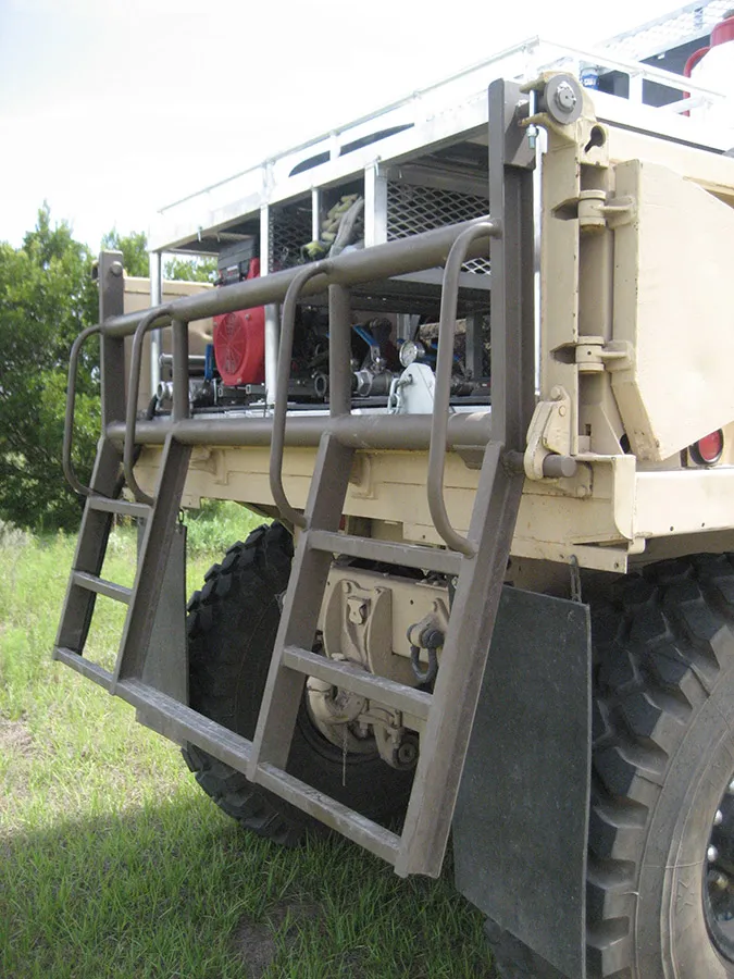 Southern Rough custom-fabricated wildland fire apparatus tailgate featuring open tube ladder design for field access to fire pump and plumbing equipment