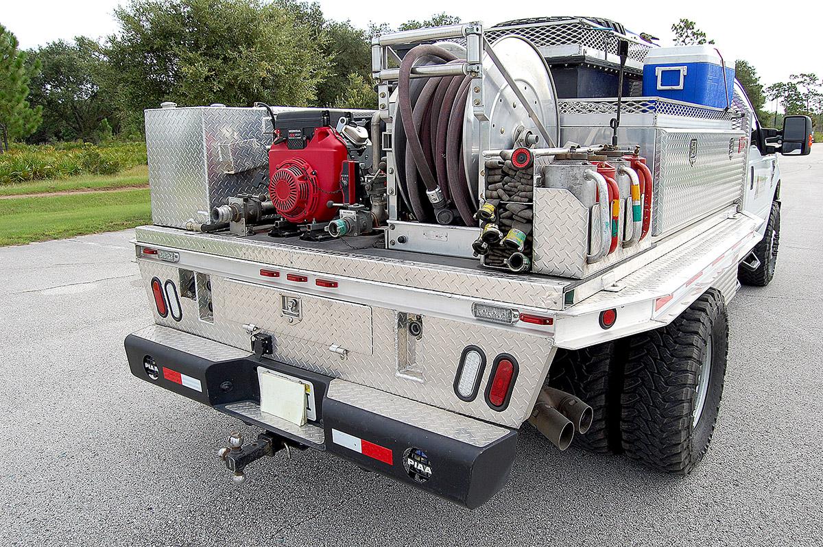 Southern Rough wildland fire engine showing easy-access quick-lay hose trays, four drip torch holders, large hose reel, and Honda pump on diamond plate bed