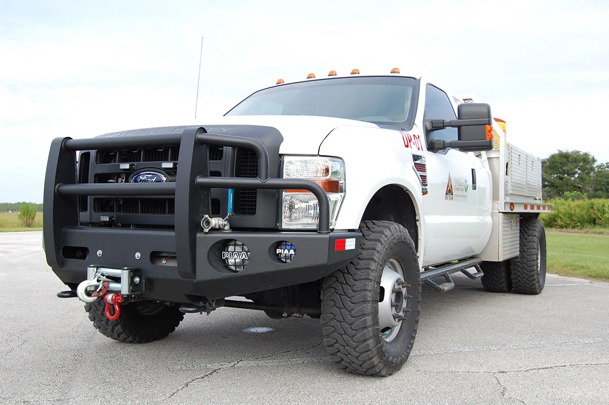 Southern Rough wildland fire engine front view showing custom heavy-duty bumper with winch, auxiliary PIAA lights, grille guard, and front discharge port