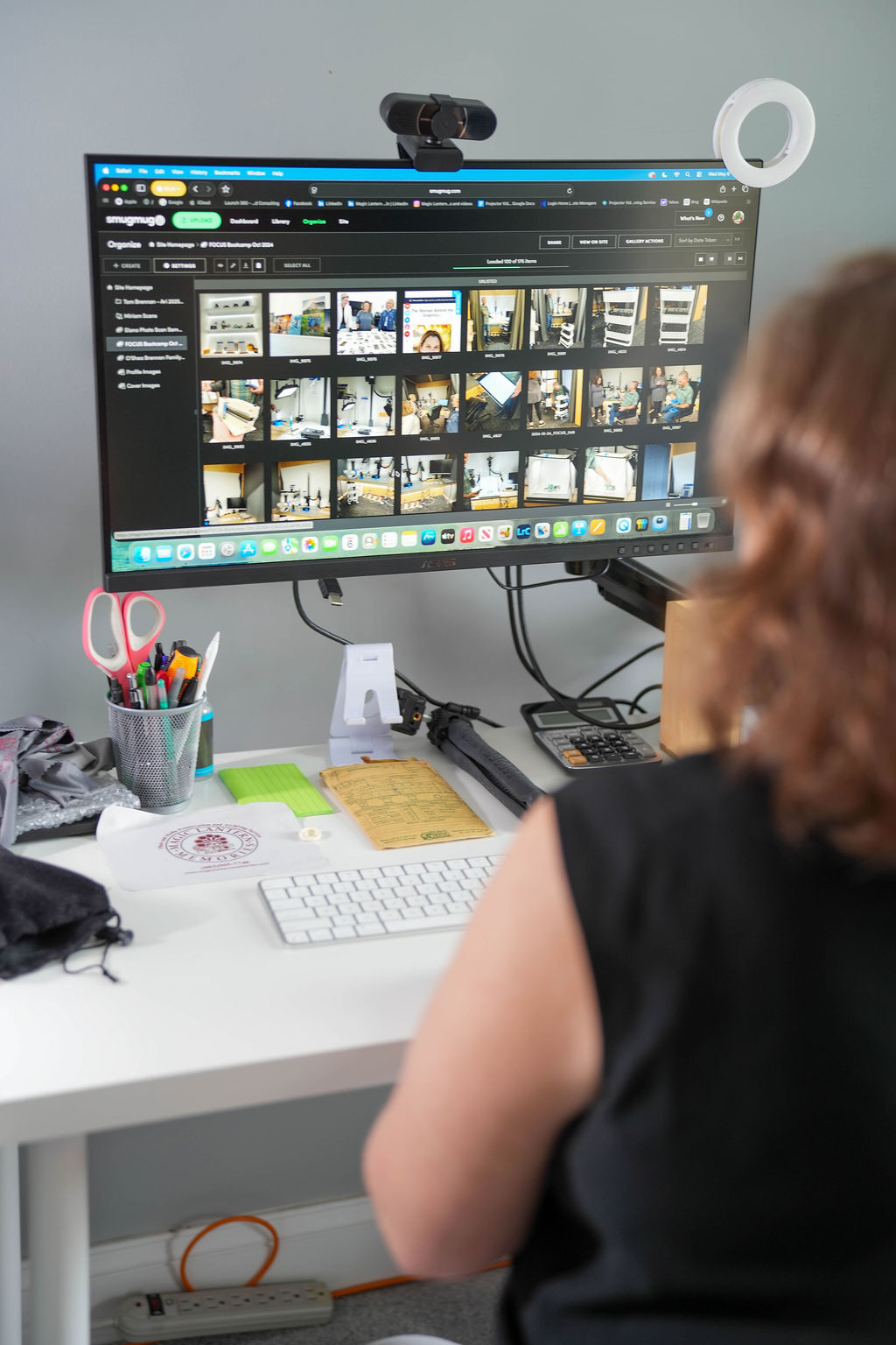 Magic Lantern Memories specialist organizing a digital photo library on a computer to create an easy-to-manage and searchable collection.