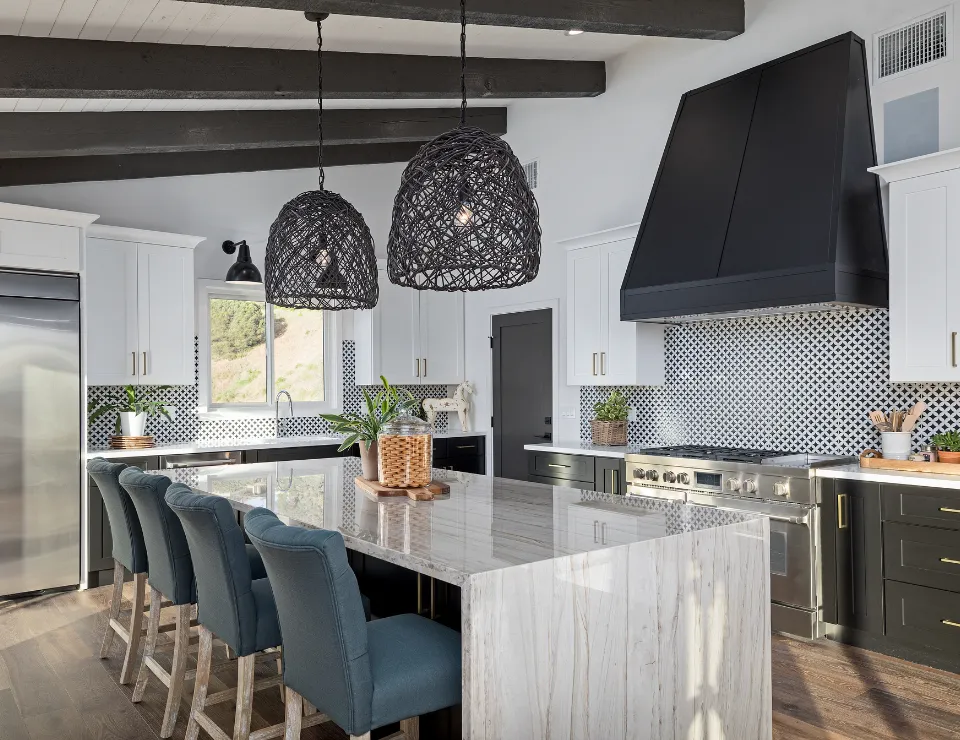 Professional handyman repairing kitchen cabinet in modern white kitchen providing expert home repair and maintenance services for homeowners in North Carolina