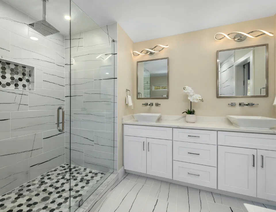 Luxury modern kitchen remodel with white cabinets quartz countertops hardwood flooring and stainless steel appliances installed by skilled remodeling contractors